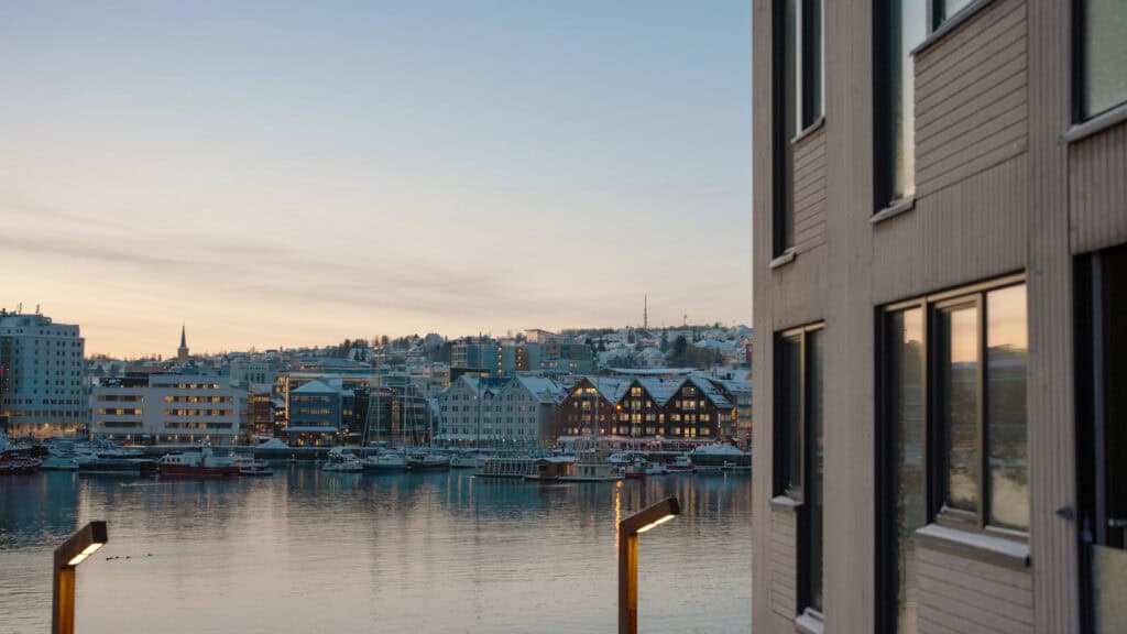 Fjorden med byens bygninger ved solnedgang, harmoni og byliv i Trondheim.